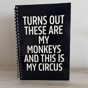 Black Spiral Notebook with White Text